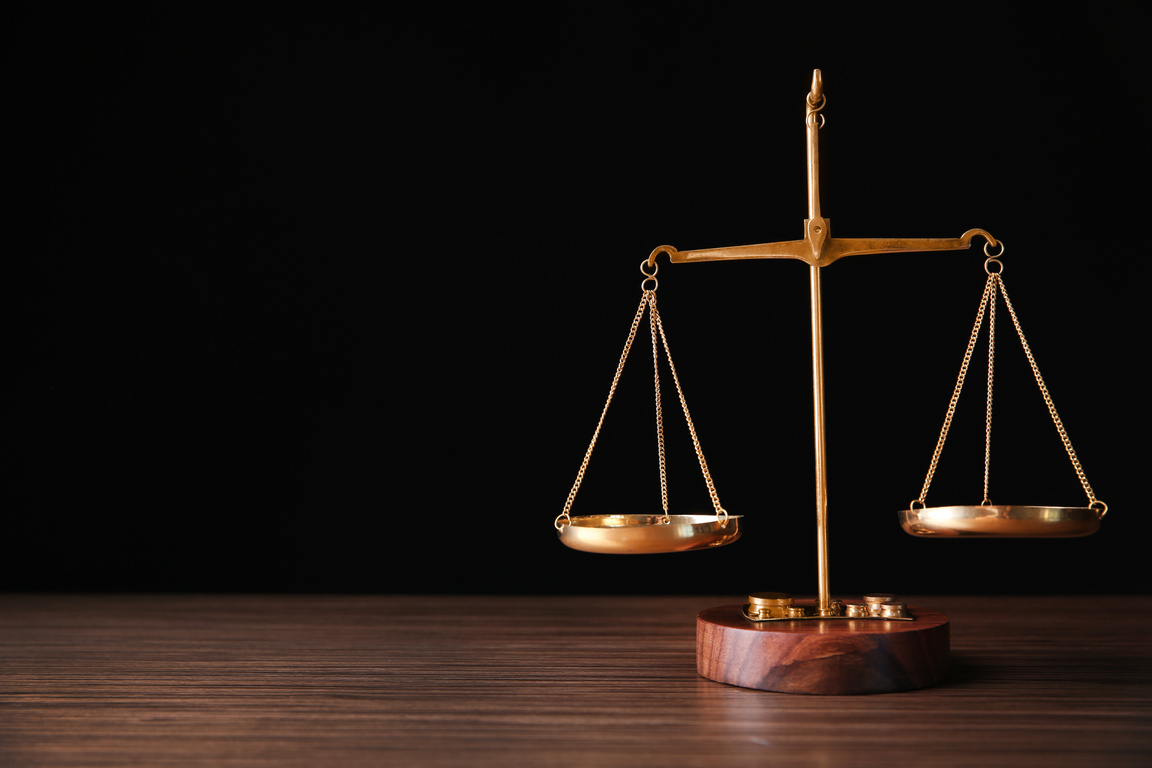 Justice Scales on Wooden Table 